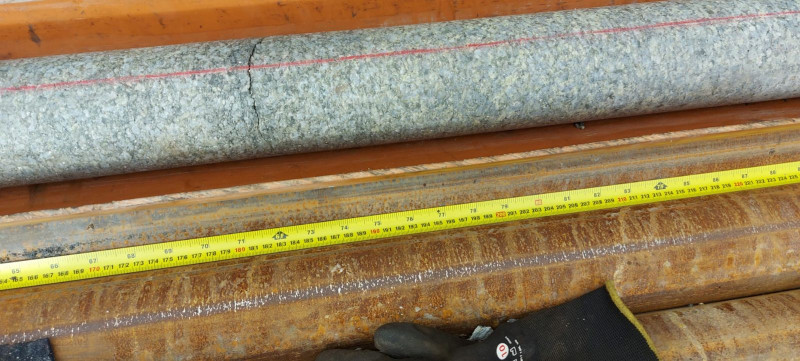 Close-up of rock core with measuring tape